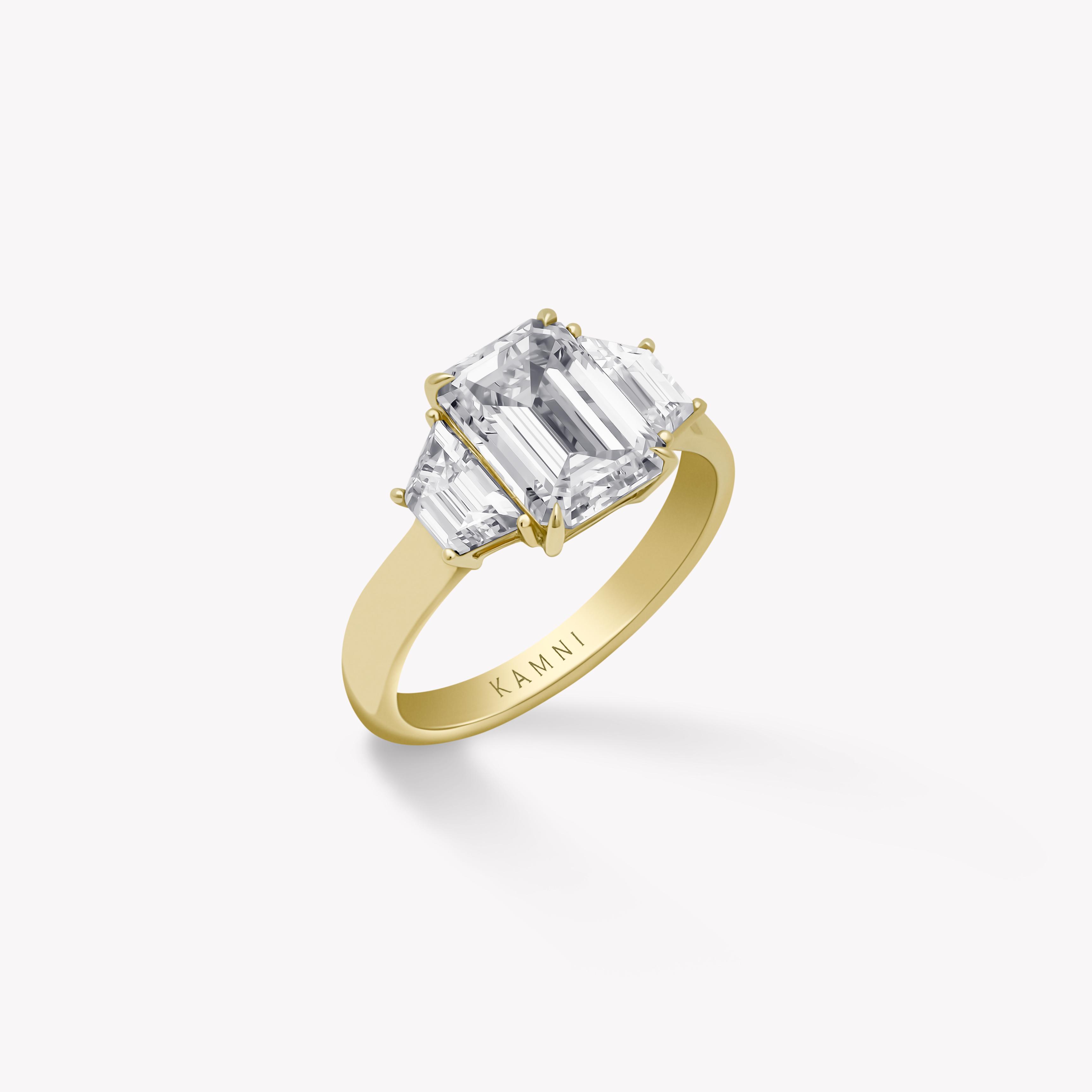 Emerald and trapezoid diamond ring